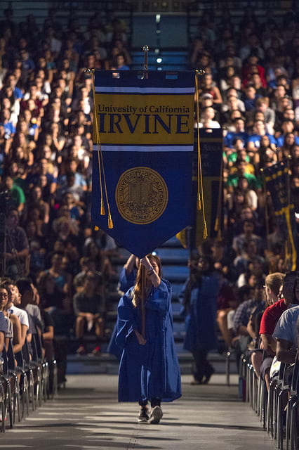Student carrying UCI symbol at event